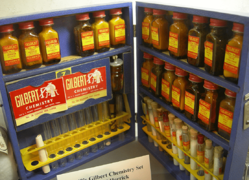 A blue cabinet with a yellow handle is filled with various bottles of chemicals. AI generated content